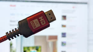 紅色HDMI線連接器插入顯示媒體內容的電腦屏幕。 — 明亮 壁紙
