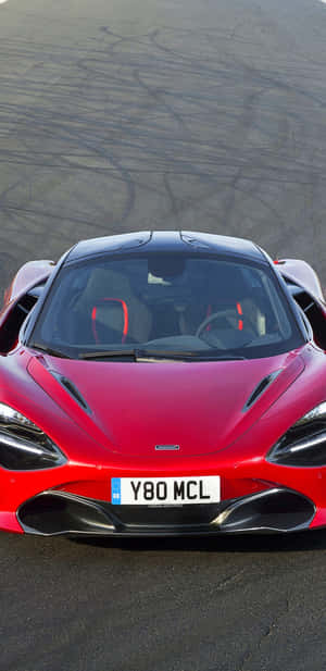 紅色McLaren跑車在帶有輪胎痕的賽道上。 — 紅色 壁紙