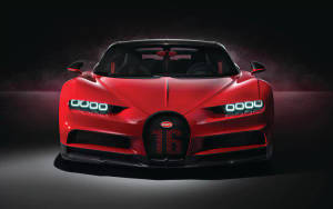 紅色Bugatti Chiron Super Sport 2020，帶有發光的頭燈和「16」標誌，在黑暗的攝影棚中。