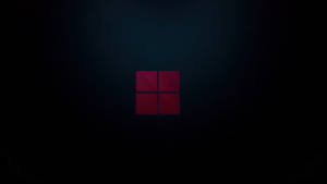 紅色Windows標誌在深色漸變背景上發光。