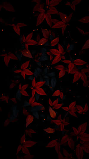 紅葉在黑暗中飄動，周圍漂浮著發光的琥珀色光芒。 — 1440x2560 壁紙