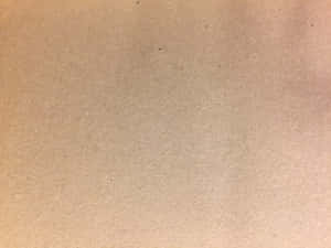 米色紋理紙張表面的特寫，帶有微妙的色調變化。 — 界王拳 壁紙