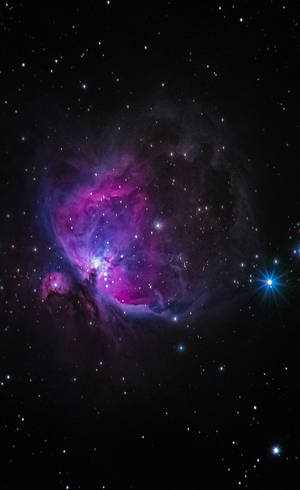 充滿活力嘅紫色同藍色星雲，被深空嘅星星包圍。
