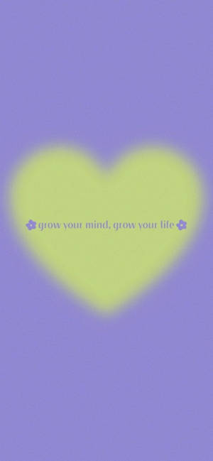 在紫色背景上帶有grow your mind grow your life文字的發光心形