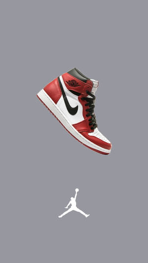 紅、白、黑色的Jordan 1波鞋配Jumpman標誌漂浮在灰色背景上。