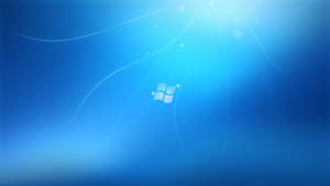 Windows 標誌居中於藍色漸變中，帶有光線和粒子 — 視窗 壁紙