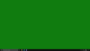 帶有綠色背景和工作列的 Windows 電腦螢幕