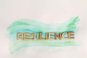 木製字母喺青綠色同薄荷綠色水彩背景上拼出「resilience」。