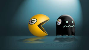 黃色 Pacman 和黑色鬼魂帶有 NFL 球隊標誌在聚光燈下對峙。