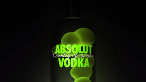 一個發光的綠色Absolut Vodka酒瓶在黑色背景上。