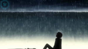一個人在夜雨中獨自坐著的剪影。 — 可憐動漫 壁紙