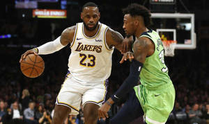 勒邦占士在NBA比賽中運球突破防守球員。 — 湖人 GIF 壁紙