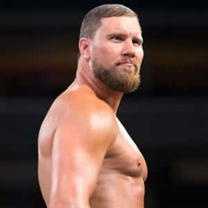 留鬍子的肌肉發達摔角手在擂台上凝視鏡頭 — WWE GIF 壁紙