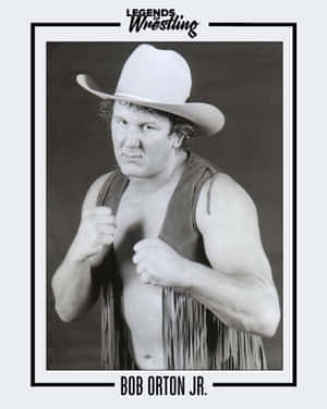 摔角手 Bob Orton Jr. 戴著牛仔帽和流蘇背心，握緊拳頭擺姿勢。
