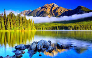 寧靜的山湖，森林倒影，霧氣籠罩的山峰，天空清澈湛藍。