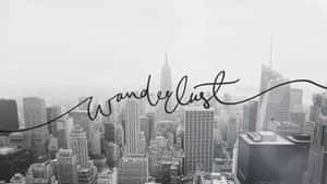 黑白城市景觀，帶有「Wanderlust」文字疊加。 — 城市 壁紙