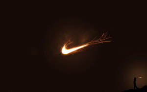 懸崖上的人手持煙花棒，在夜空中形成Nike標誌。