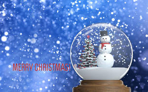 雪球內有雪人和樹，藍色雪景背景上寫有「Merry Christmas」文字。 — 聖誕快樂 GIF 壁紙