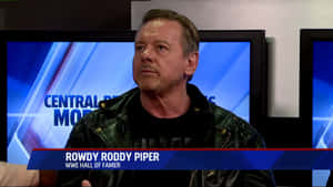 WWE名人堂成員 Rowdy Roddy Piper 在新聞採訪中身穿皮褸。