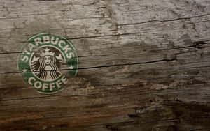 Starbucks咖啡標誌塗在風化的木質表面上。
