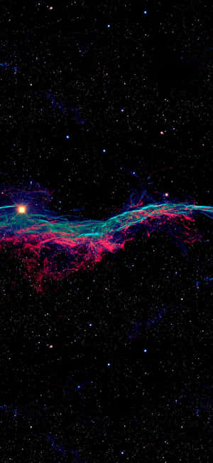 發光的粉紅色和藍綠色宇宙星雲，在佈滿星星的黑色天空中閃耀。