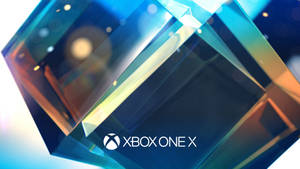 閃亮的幾何水晶，Xbox One X 標誌閃爍著藍色和金色光芒。