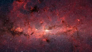 深空中一個帶有發光星星和宇宙塵埃的鮮豔紅色和橙色星雲。