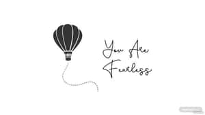 黑色熱氣球，帶有虛線軌跡和手寫文字 You Are Fearless，背景為白色。