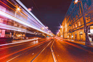 夜晚城市街道，有車輛和街燈的光軌。 — Huawei 壁紙