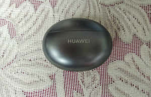 黑色Huawei耳機盒在圖案布料背景上