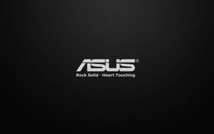 ASUS 品牌標誌，附有標語 Rock Solid Heart Touching，置於深色紋理背景上。