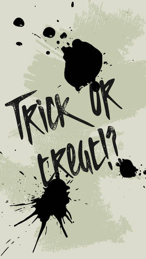 萬聖節主題文字「Trick or Treat!」在淺綠色背景上帶有黑色墨水飛濺。