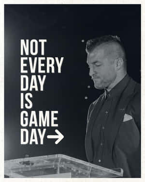 西裝男子在講台前，帶有激勵文字 not every day is game day