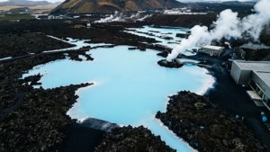 俯瞰一個被黑色火山岩和蒸汽通風口環繞的藍色地熱湖。