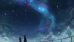 兩個人站在欄杆上，看著有彩色星雲的星空。