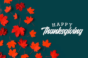紅色楓葉和深青綠色背景上的「Happy Thanksgiving」文字 — 3:2 壁紙