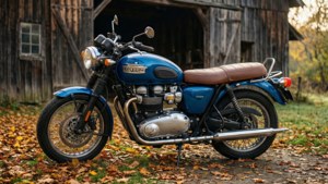 經典藍色 Triumph 電單車停放在木穀倉附近的秋葉上