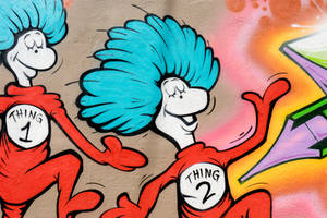 Dr. Seuss的Thing 1和Thing 2塗鴉壁畫，藍色頭髮和紅色服裝，正在跳舞。