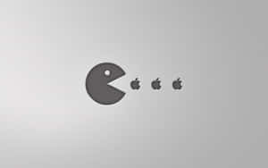 Pac-Man 在銀色表面上吃 Apple 標誌。