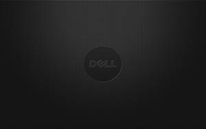 黑色紋理Dell筆記本電腦蓋，帶有中央標誌和漸變燈光。