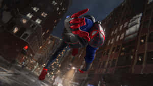 蜘蛛俠在夜晚穿越白雪覆蓋的城市，雪花飄落。 — 超級英雄 壁紙