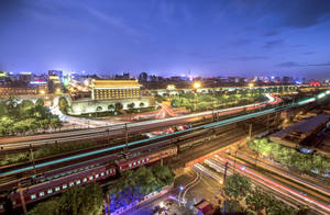 夜間城市場景，帶有車流的光跡和照亮的歷史城牆。 — 唐人街 GIF 壁紙