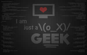 深色背景，帶有程式碼和文字「I am just a geek」，並有一個紅色心形圖示。 — 程式碼 壁紙