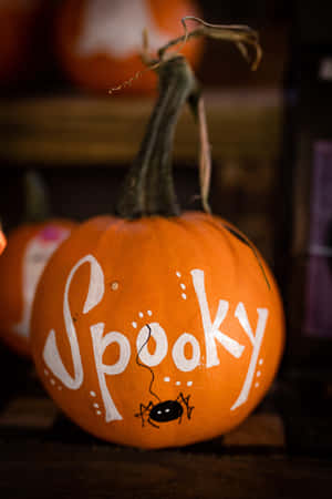 一個裝飾有「Spooky」字樣和蜘蛛的橙色南瓜。