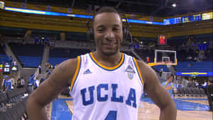 UCLA籃球運動員在球場上微笑戴著耳機