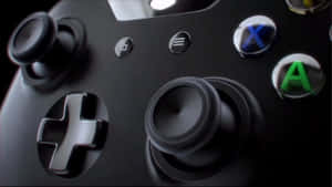 黑色Xbox遊戲手掣嘅特寫，帶有發光按鈕。 — Xbox GIF 壁紙