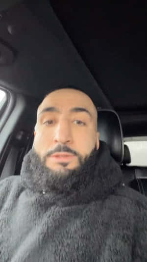 車內穿著灰色絨毛連帽衫的鬍子男。