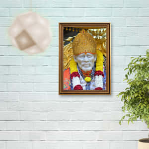 白色磚牆上裱框的印度教神祇肖像，附近有盆栽植物。 — 聖人 GIF 壁紙
