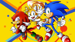 Sonic Tails 和 Knuckles 在色彩繽紛的幾何背景上豎起大拇指競速。 — 設計 壁紙