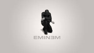 一個戴帽子的人蹲著，下方有文字「EMINEM」。